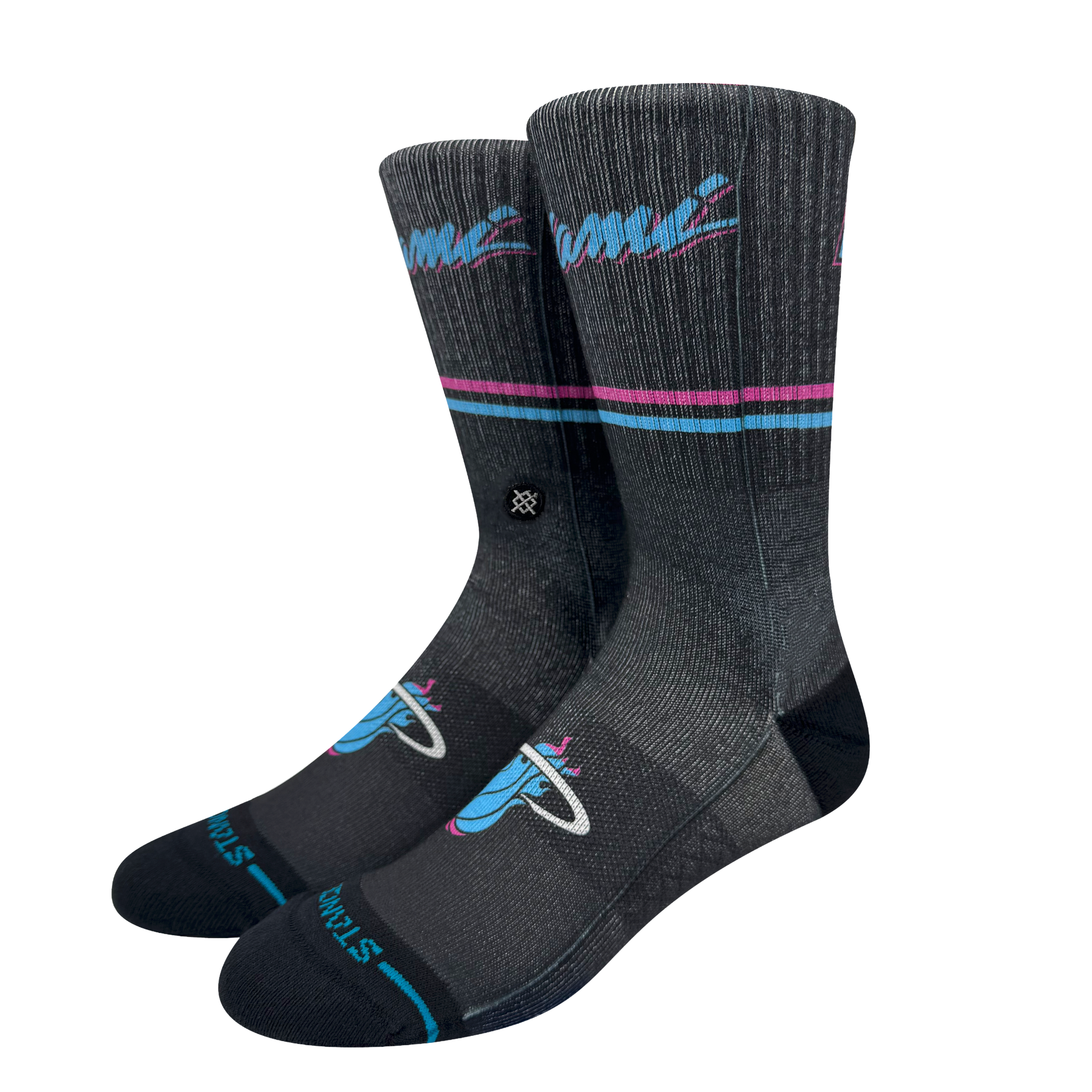 The Stance Miami HEAT Original Vice Nights Socks feature teal and pink stripes, a flaming basketball logo, and “Finals” near the toes. These dark gray crew socks have a ribbed texture and mid cushion, shown upright against a plain background.