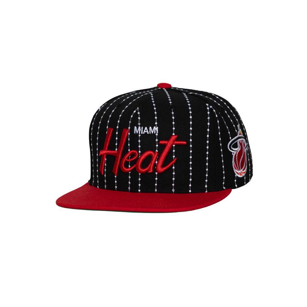 The Mitchell & Ness Miami HEAT Pinstripe Snapback is a black polyester cap with white pinstripes, red flat brim, Heat embroidery in red and white, team logo on the side, easy spot clean design, and adjustable fit.