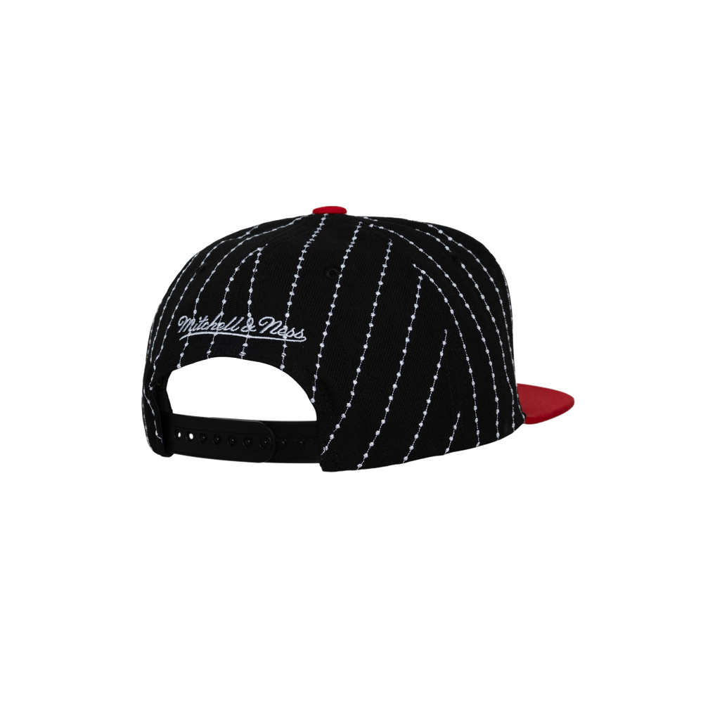 The Mitchell & Ness Miami HEAT Pinstripe Snapback features black and white pinstripes, a red bill, white embroidered branding above the adjustable strap, polyester material, a one size fits most design, and easy spot cleaning.