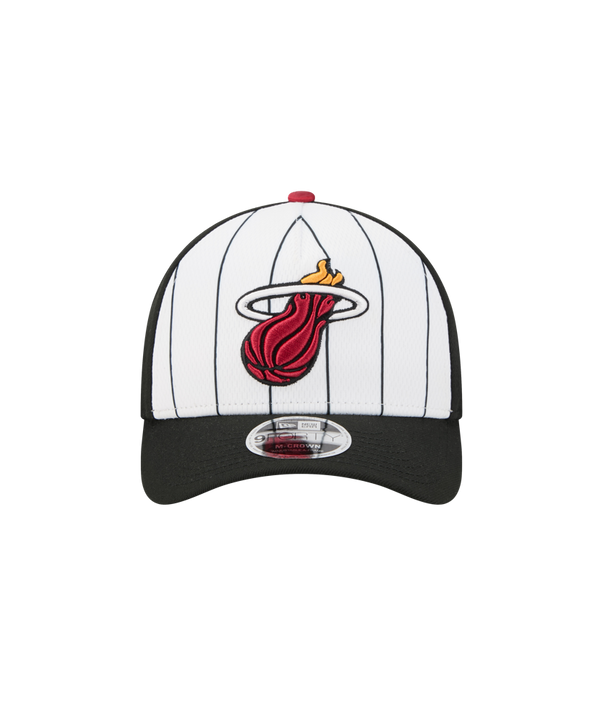 The New Era Miami HEAT 2025 Tipoff Snapback features black pinstripes, a black brim, and the flaming basketball logo, finished with a classic silver New Era sticker on the brim.