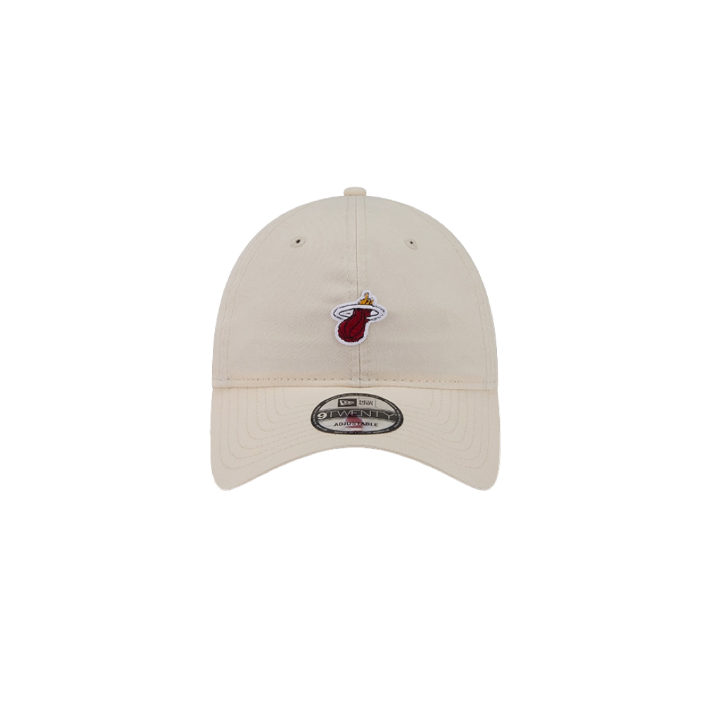 The New Era Miami HEAT Micro Logo Dad Hat is a beige cotton cap with the team logo embroidered on the front and a New Era sticker on the curved brim. Shown on a white background. One size fits most; spot clean for best results.