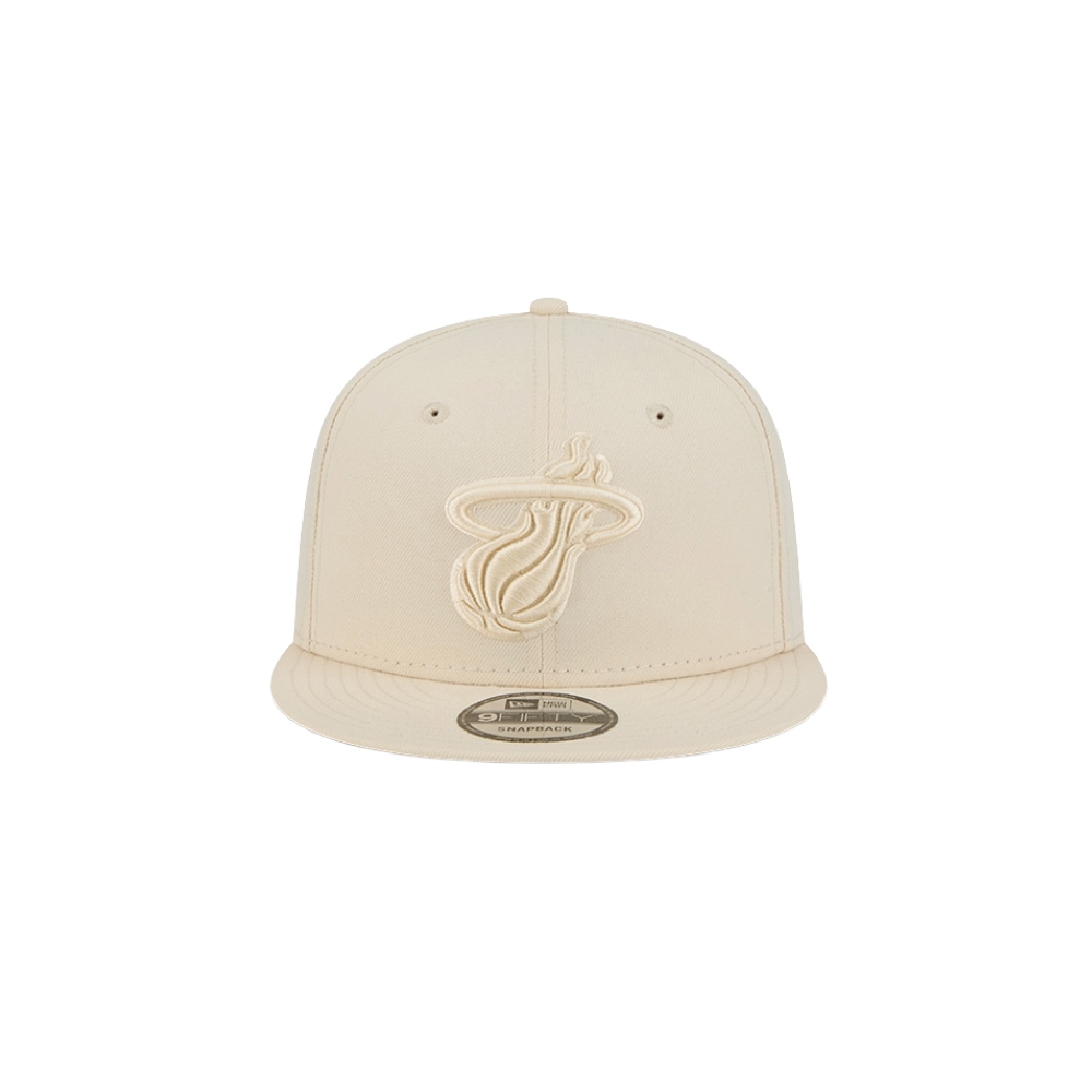 The New Era Miami HEAT Beige Color Pack Snapback features a beige polyester build with the team logo embroidered in matching beige on the front. One size fits most. Product is shown against a plain white background.