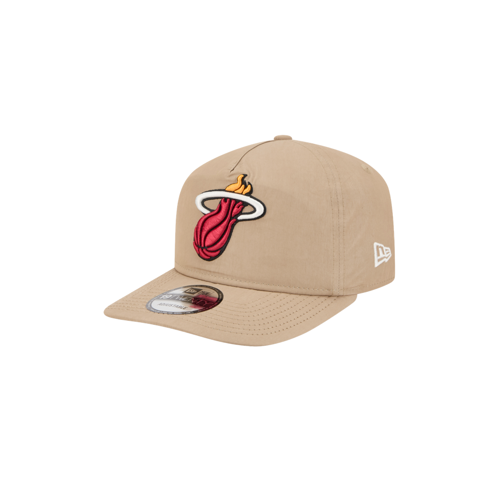 The New Era Miami HEAT Nylon Tan Snapback features the team's logo on the front, a white New Era logo on the side, a cotton nylon flat brim with sticker, and an adjustable snapback closure.