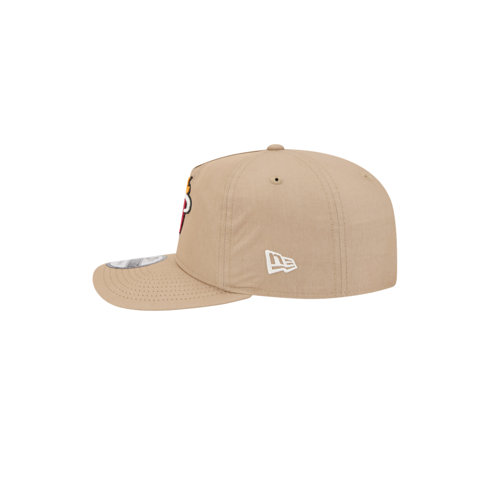 The New Era Miami HEAT Nylon Tan Snapback is shown side view on a white background, with a white New Era logo embroidered on the side and part of a colorful design visible on its cotton nylon visor.
