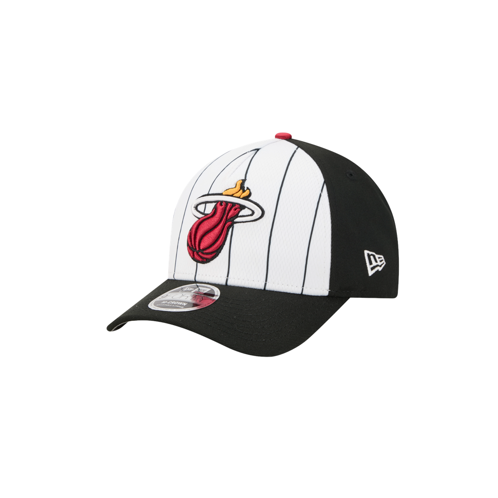 The New Era Miami HEAT 2025 Tipoff Snapback features black and white vertical pinstripes, the team’s flaming basketball logo on the front, and a New Era logo on the side.
