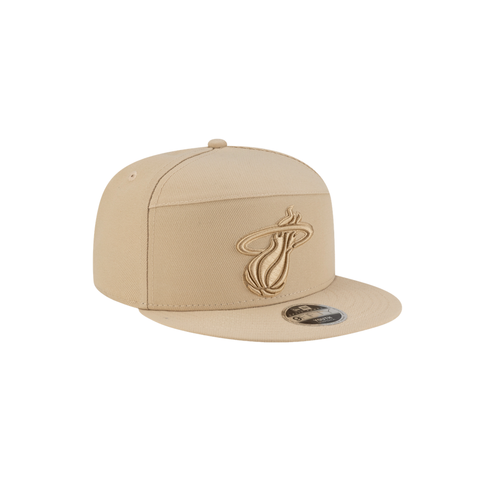 The New Era Miami HEAT Tan Youth Snapback is a beige polyester cap featuring the Miami Heat logo embroidered on the front. Displayed angled on white, it's one size fits most and easy to spot clean.