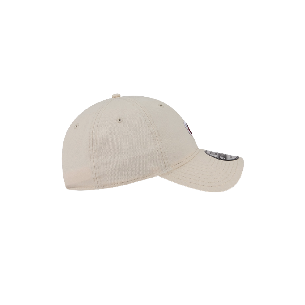The New Era Miami HEAT Micro Logo Dad Hat, a beige cotton baseball cap with a curved brim and six-panel design, is shown from the side against a plain white background; one size fits most.