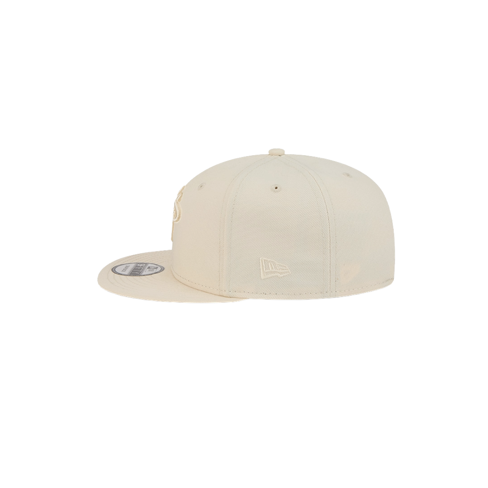 The New Era Miami HEAT Beige Color Pack Snapback is shown from the side on a white background, featuring a flat brim, subtle embroidered logo, and polyester build. One size fits most; spot clean for best care.