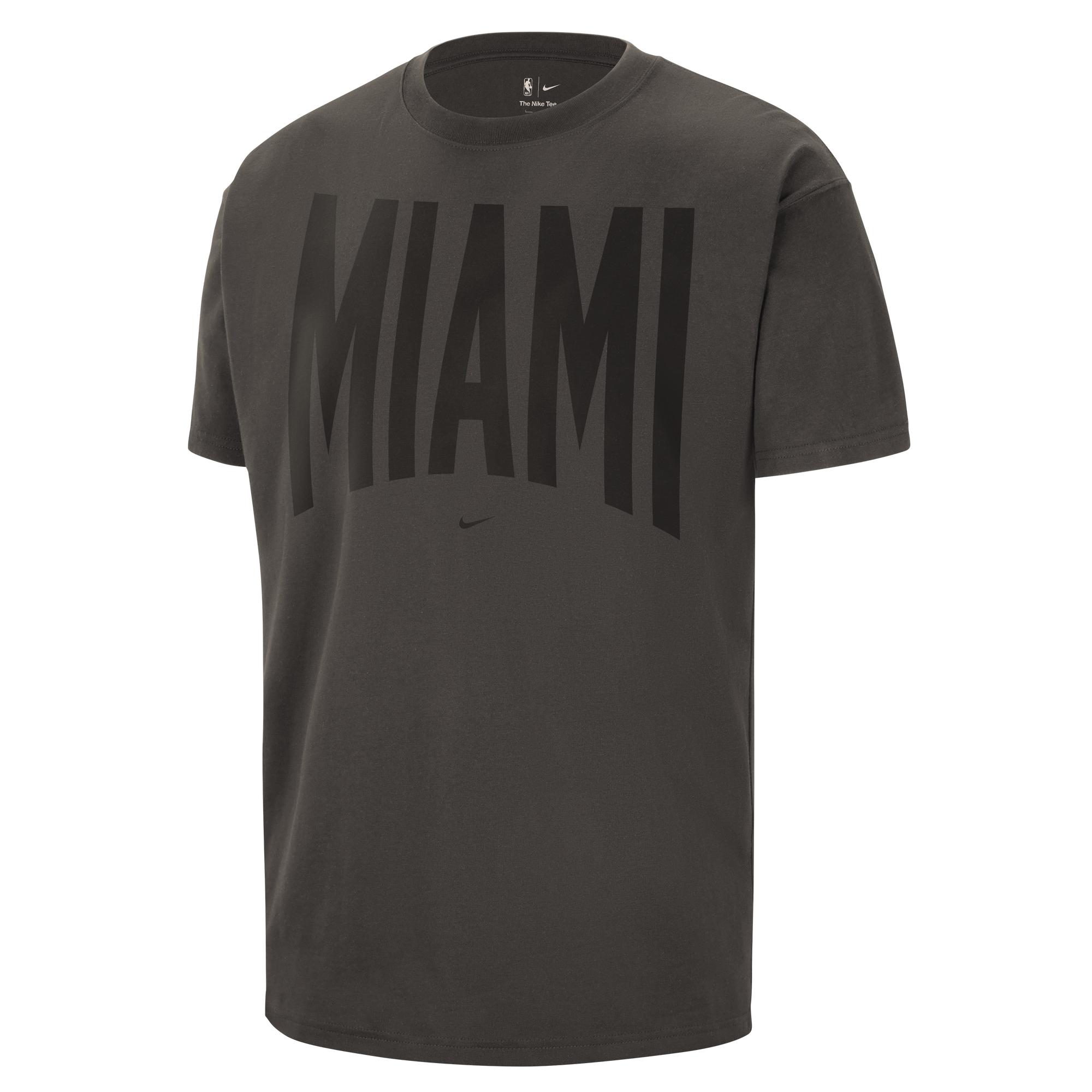 Introducing the Nike Miami HEAT Black Travel Tee: a dark gray cotton t-shirt with “MIAMI” boldly displayed in large black letters across the chest and a signature Nike logo centered just below. Perfect for any Miami HEAT fan on the go!.