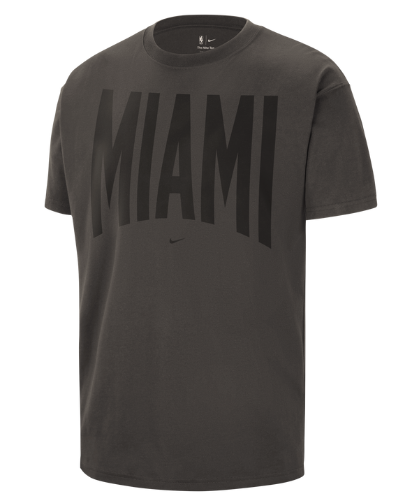 Introducing the Nike Miami HEAT Black Travel Tee: a dark gray cotton t-shirt with “MIAMI” boldly displayed in large black letters across the chest and a signature Nike logo centered just below. Perfect for any Miami HEAT fan on the go!.