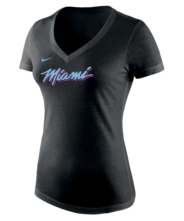 The Nike Miami HEAT Original Vice Nights Women's V-Neck Tee features “Miami” in pink and blue script, a small blue Nike logo above, is made from soft polyester-cotton-rayon, and is shown on a plain white background. Wash with like colors.