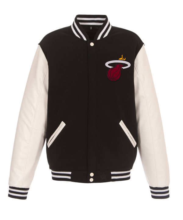 Two black JH Designs Miami HEAT Reversible Varsity Jackets with white-striped collars/cuffs, embroidered red basketball in white flaming hoop logo. One jacket has faux leather sleeves, the other features black sleeves.