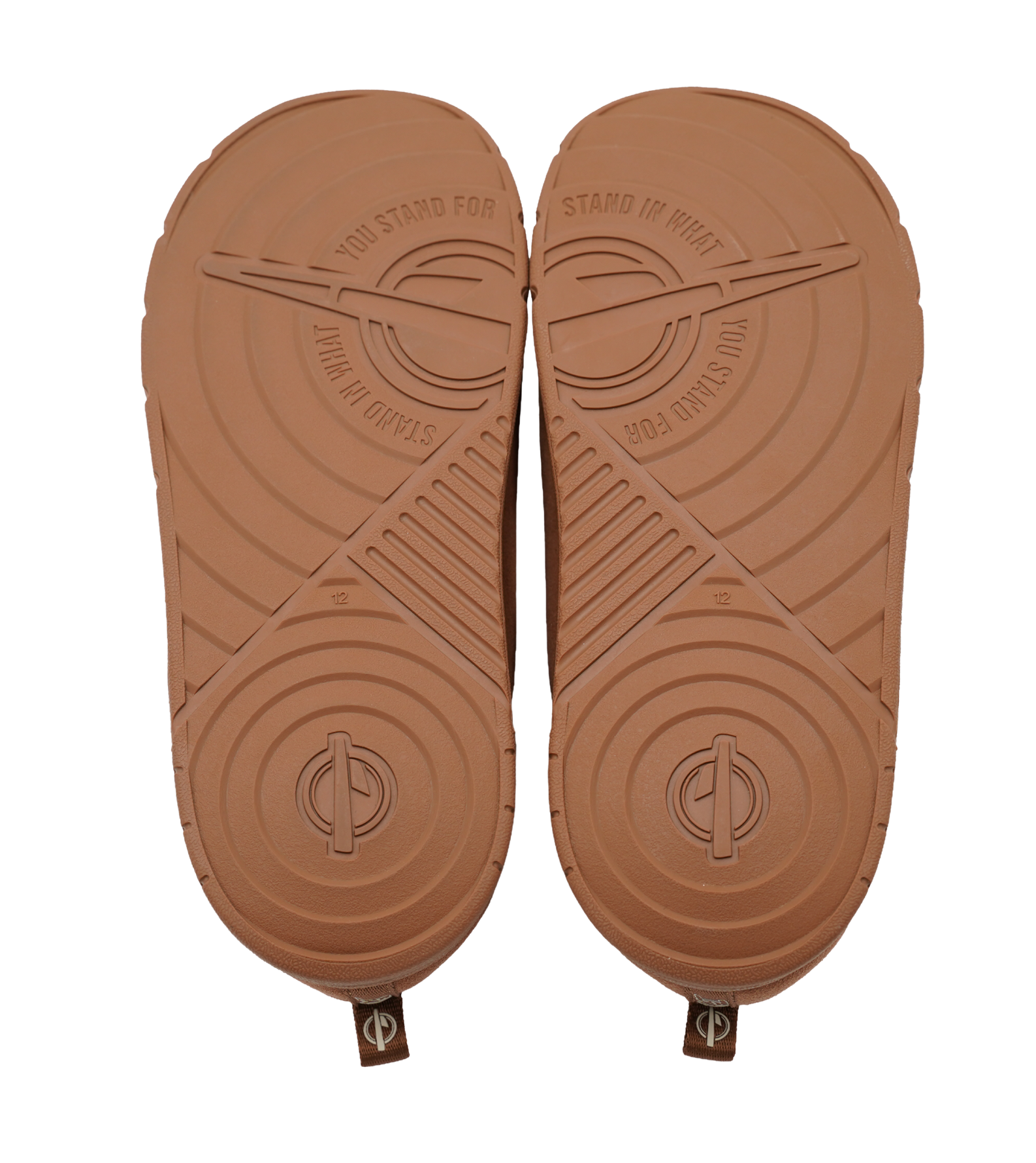 Bottom view of a pair of tan ISlide Miami HEAT Cream Logo Mission Slipper slides showing the textured soles with the embossed text STAND IN WHAT YOU STAND FOR.