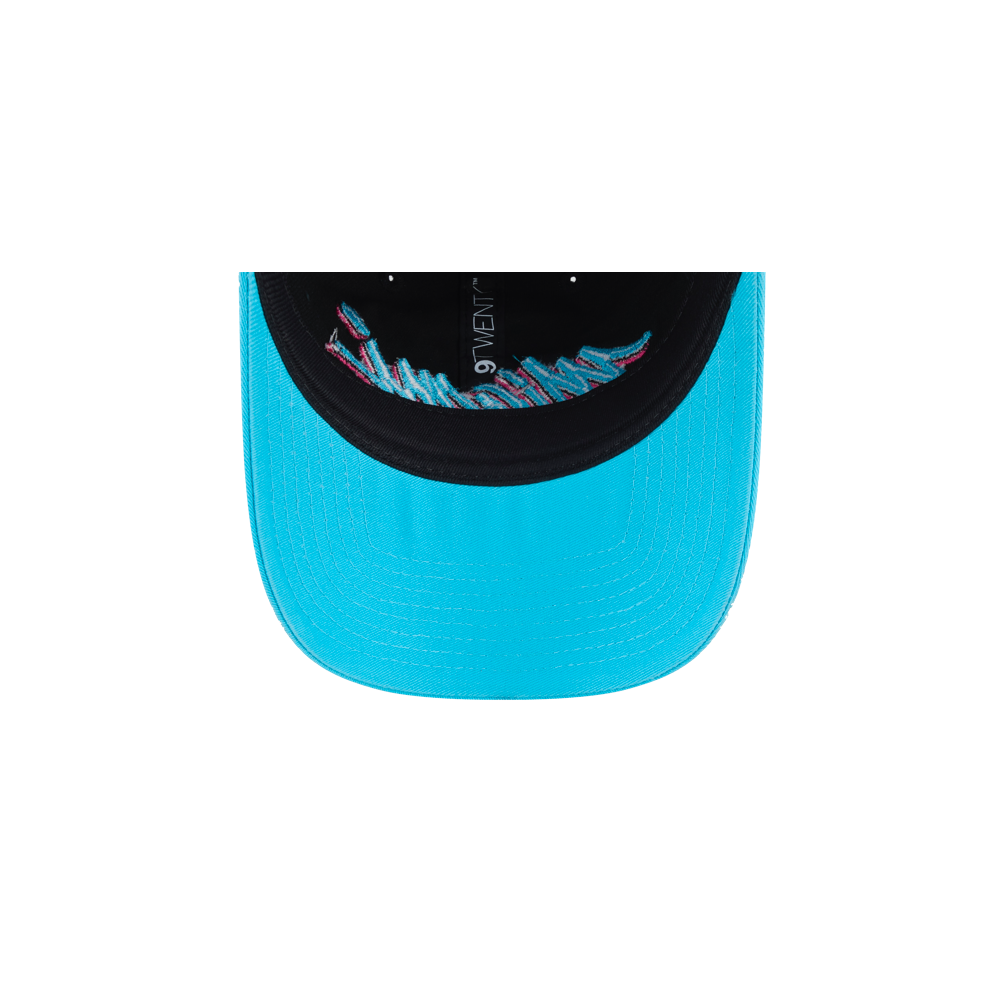 The New Era Miami HEAT Original Vice Nights Wordmark Dad Hat in turquoise cotton features black inner lining, colorful embroidered text along the brim’s edge, and a one-size-fits-most design—seen here from underneath.