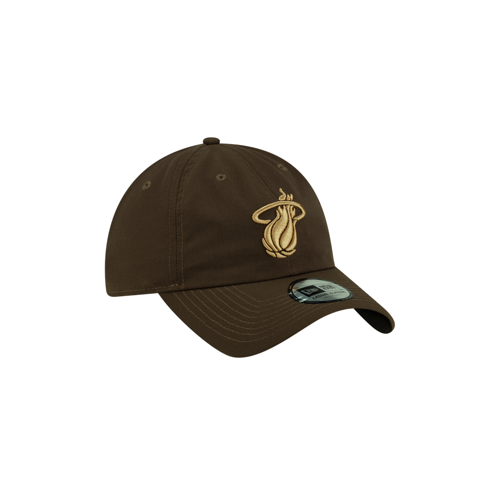 Court Culture x New Era Olive Dad Hat, an olive-colored polyester baseball cap featuring an embroidered tan basketball and flame logo on the front.