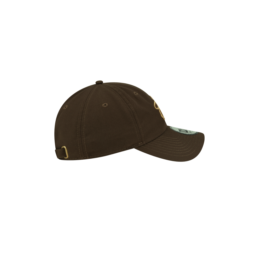 Court Culture x New Era Olive Dad Hat, an olive-colored polyester baseball cap featuring a gold embroidered logo on the front and an adjustable strap on the back.