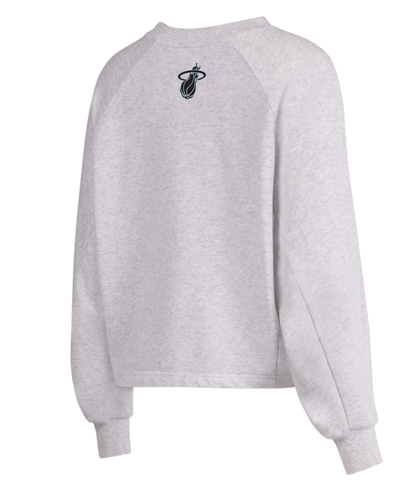 The G-III Miami HEAT Faceoff Women's Crewneck by G-III Sports is a light gray, relaxed-fit sweatshirt with MIAMI in large, light blue outlined letters across the chest. Features ribbed cuffs, crew neck, cotton-poly blend. Machine wash cold.