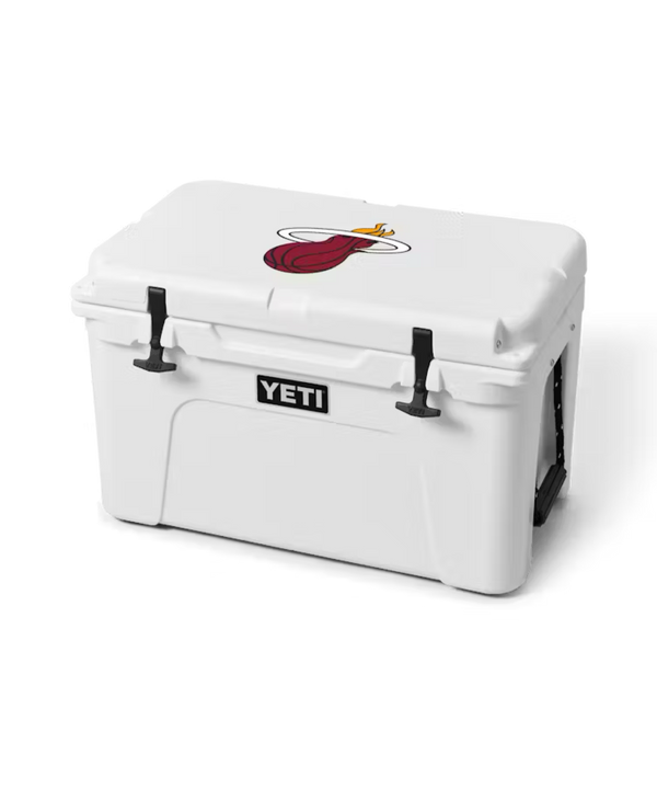 The Yeti Miami HEAT Tundra® 45 Cooler features PermaFrost insulation and a lid with a cartoon red tongue, gold halo, and wings design. Shown on a plain white background.